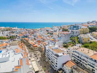 an aerial view of a city with buildings and the ocean at Old Town Soul in Albufeira
