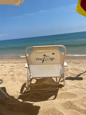 a beach chair sitting on the sand at the beach at Serenity-First villa in Albufeira