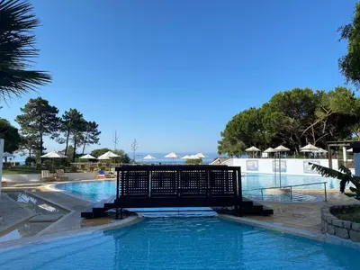 a swimming pool with blue water in a resort at Serenity-First villa in Albufeira