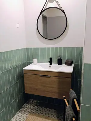a bathroom with a sink and a mirror at Grey and Green, modern 2-bedroom apartment, AC, top location at faro's historic centre in Faro