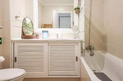 a white bath tub in a bathroom with a sink at Apart Salgados Village - Near to the Beach - BY BEDZY in Guia