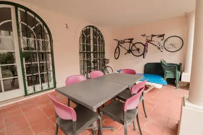 a dining room with a table and chairs and bikes on the wall at Old Village - Vilamoura T0 com pátio in Bicas