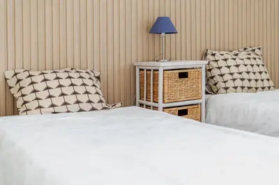 a bedroom with two beds and a table with a lamp at Maison Du Soleil by Seareen in Albufeira