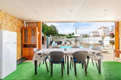 a dining room with a table and chairs at Maison Du Soleil by Seareen in Albufeira