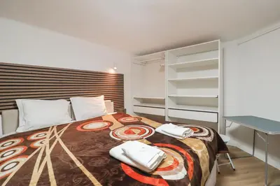 a bedroom with a bed with two phones on it at Solar do Golf T1 Vilamoura Old Village in Quarteira