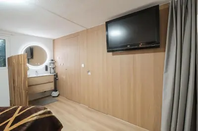a bedroom with a flat screen tv on a wall at Solar do Golf T1 Vilamoura Old Village in Quarteira