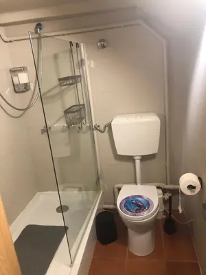 a small bathroom with a shower and a toilet at Solar do Golf T1 Vilamoura Old Village in Quarteira