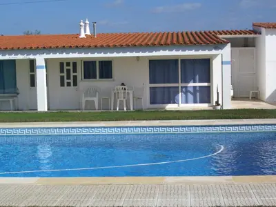 a villa with a swimming pool in front of a house at Maison A Quinta V1 4 Personnes in Ferreiras