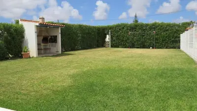 a large yard with a fence and a field of grass at Maison A Quinta V1 4 Personnes in Ferreiras