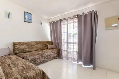 a bedroom with a couch and a large window at Maison A Quinta V1 4 Personnes in Ferreiras