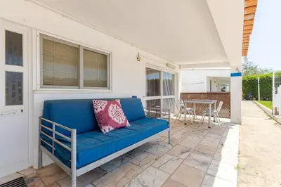 a blue couch on a patio with a table at Maison A Quinta V1 4 Personnes in Ferreiras