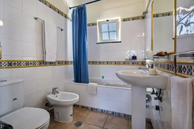a bathroom with a sink and a toilet and a tub at Rebela 1st Algarve Villa Holidays in Albufeira