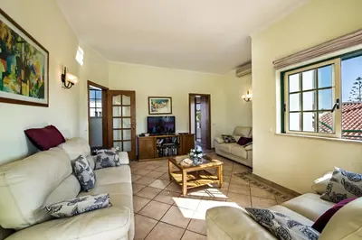a living room with couches and a tv at Rebela 1st Algarve Villa Holidays in Albufeira