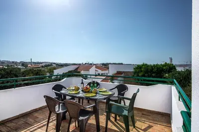 a balcony with a table with food on it at Rebela 1st Algarve Villa Holidays in Albufeira