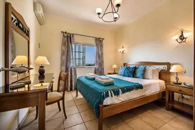 a bedroom with a bed and a desk and a mirror at Rebela 1st Algarve Villa Holidays in Albufeira