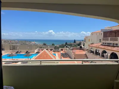 a view of a pool from a window of a building at Amazing Sea View Studio w Pool in Albufeira