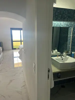 a bathroom with a sink and a mirror at Amazing Sea View Studio w Pool in Albufeira