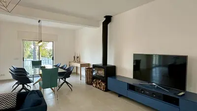 a living room with a flat screen tv and a fireplace at Cruzeiro by Check-in Portugal in Quarteira