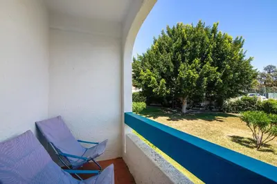 a kitchen with a white refrigerator and a stove at Santiago’s Oura House in Albufeira
