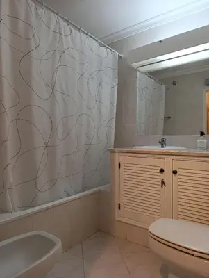 a bathroom with a sink and a shower curtain at Balaia Golf Village 122 in Albufeira