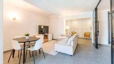a living room with a white couch and a table at Modern Studio with Balcony in Salgados by Lovelystay in Guia
