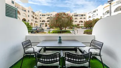 a table and chairs on the balcony of a building at Modern Studio with Balcony in Salgados by Lovelystay in Guia