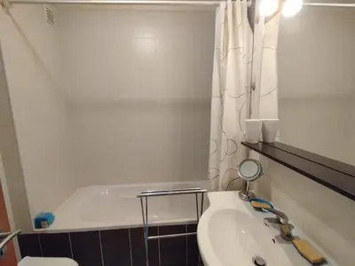 a bathroom with a tub and a toilet and a sink at São rafael Ocean View in Albufeira