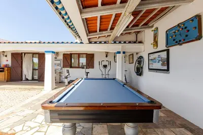 a pool table in a room with a ceiling at Maison A Quinta V2A 5 Personnes in Ferreiras