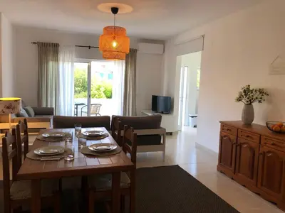 a kitchen with white cabinets and a stove at Apt H - Beach Village in Olhos de Água