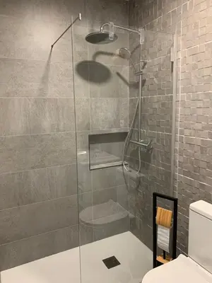 a shower with a glass door in a bathroom at Açoteias Falésia Studio Apartment in Olhos de Água