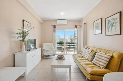 a living room with a couch and a table at Stork nest in Vilamoura