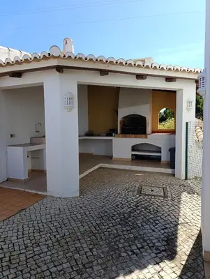 a white house with a kitchen and a patio at Villa Inês in Guia