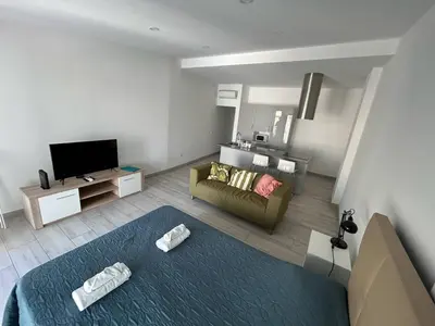 a living room with a couch and a tv at Casa Susana in Faro