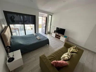 a living room with a bed and a couch at Casa Susana in Faro