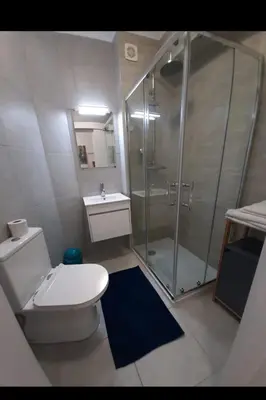 a bathroom with a shower and a toilet and a sink at T0 close to the beach and the city center in Albufeira