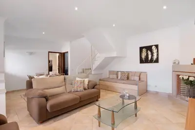 a living room with a couch and a fireplace at Villa Neves in Albufeira