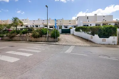 an empty street in front of a building at Villa Neves in Albufeira