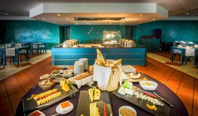 a buffet line with food in a restaurant at Hotel Vila Galé Cerro Alagoa in Albufeira