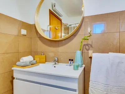 a bathroom with a sink and a mirror at AL Vilamoura Porto Marina in Vilamoura