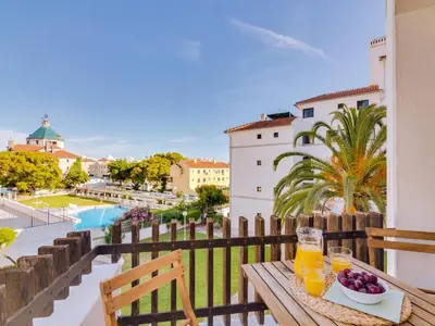 a table with glasses of orange juice and fruit on a balcony at AL Vilamoura Porto Marina in Vilamoura