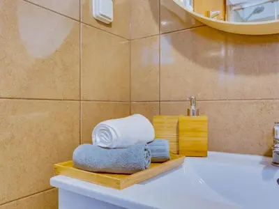 a bathroom with a sink and towels on a counter at AL Vilamoura Porto Marina in Vilamoura