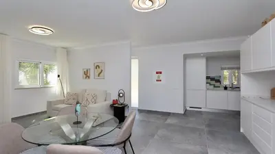 a living room with a table and a couch at Monte Verde B CD 294 - Cleverdetails, Sleeps 2 adults and 2 children, 4 salted water pools in Quarteira