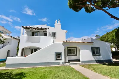 a white house with a steeple at Monte Verde B CD 294 - Cleverdetails, Sleeps 2 adults and 2 children, 4 salted water pools in Quarteira