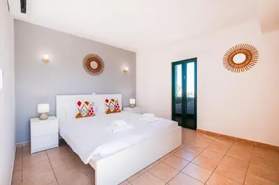 a bedroom with a white bed in a room at Villa Lamella in Albufeira