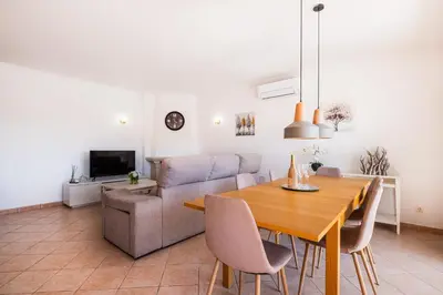 a living room with a table and a couch at Villa Lamella in Albufeira