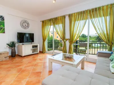 a living room with a couch and a tv at Quinta do Paiva Apartment by Stay ici Algarve Holiday Rental in Albufeira