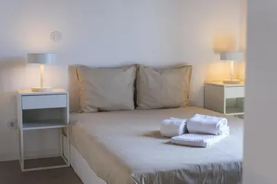 a bed with two towels on it with two lamps at Marina Club II - Marina view by HD in Vilamoura