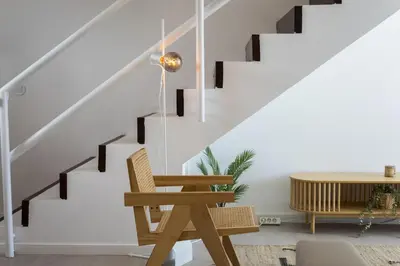 a room with a chair and a staircase at Marina Club II - Marina view by HD in Vilamoura