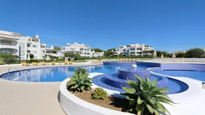 a swimming pool with a fountain in a resort at Monte Verde C - CD 295, Cleverdetails, Sleeps 2 adults and 2 children, 4 salted water pools in Vilamoura