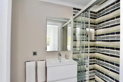 a bathroom with a sink and a mirror at Monte Verde C - CD 295, Cleverdetails, Sleeps 2 adults and 2 children, 4 salted water pools in Vilamoura